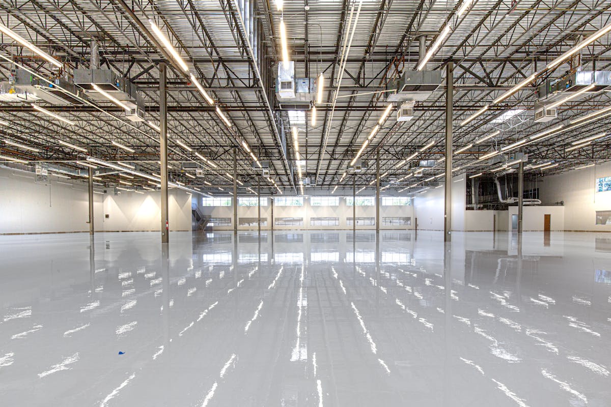 Glossy polished warehouse floor finished with polyaspartic or epoxy coating system